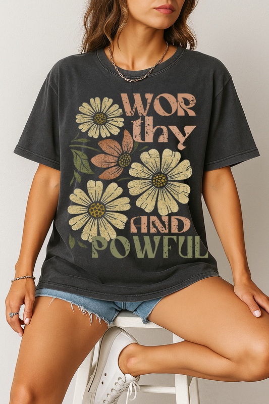 Show the world your strength and beauty with our Worthy and Powerful Floral Graphic Tee. This oversized vintage charcoal t-shirt features a bold distressed print with blooming daisies and empowering typography that reminds you of your value and inner power. Made for comfort and styled to inspire, it’s perfect for layering or wearing solo with your favorite denim. Whether you’re running errands or making moves, this tee keeps your spirit front and center.